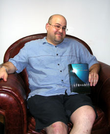 David Louis Edelman holding a copy of Infoquake